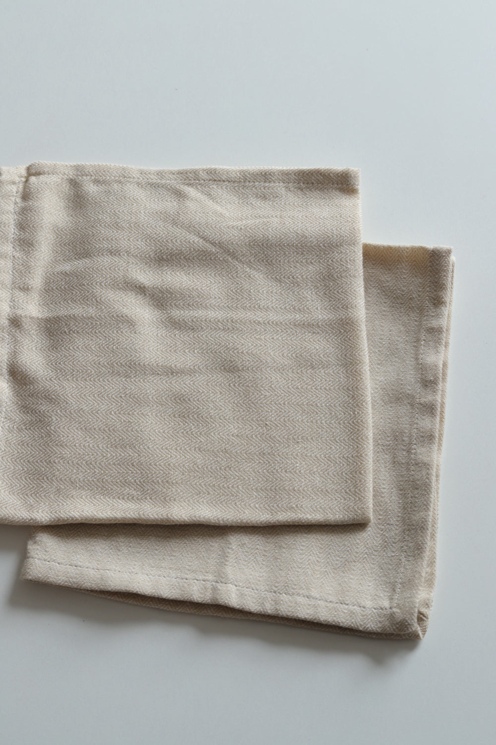 Two herringbone weave neutral napkins